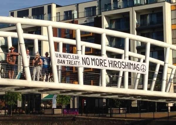 Members of Bedford CND with their banner on the town's Riverside North Bridge