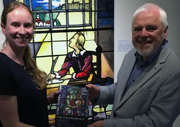 John Bunyan gifted book - Professor W.R Owens officially donating the book to Nicola Sherhod, Curator of the John Bunyan Museum and Library