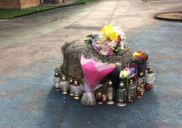 Floral tributes have been laid at the scene of the shooting in Leven Walk Brickhill