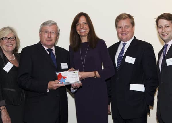 From left: Christine Field, Colin Field, Jeremy Field and Charlie Field being presented the award by Penny Lovell, one of the sponsors and judges, centre..