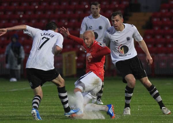 Luke Guttridge makes a challenge in the sodden conditions at Gateshead