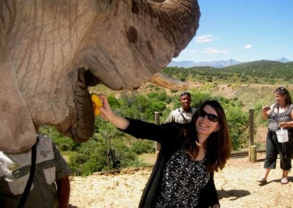 Travel writer Diana Pilkington feeds an elephant at Buffelsdrift Game Lodge in Oudtshoorn, South Africa. Picture: PA Photo/Diana Pilkington.