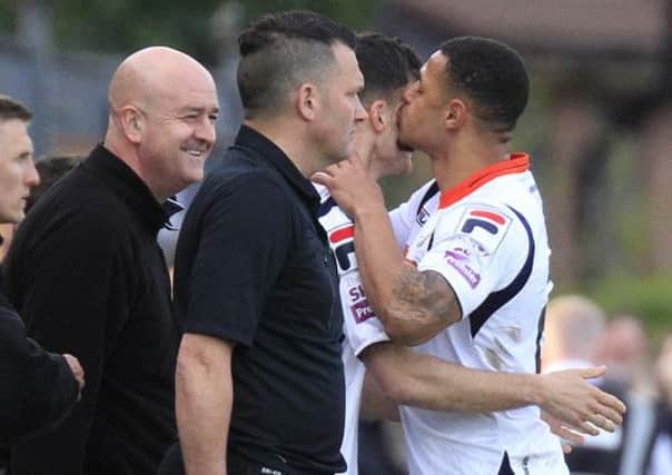 Jonathan Smith gets a kiss from Andre Gray after coming on against Hyde