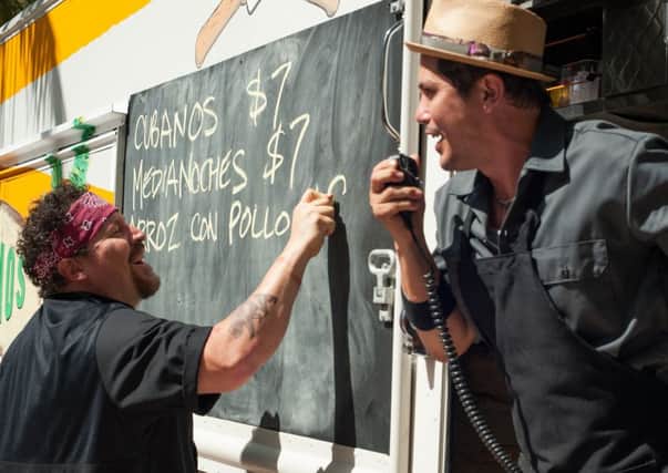 Jon Favreau chalks up the daily specials in Chef