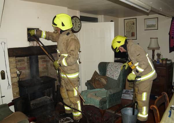 Firefighters using stirrup pump and rods in chimney Eversholt PNL-161101-102043001