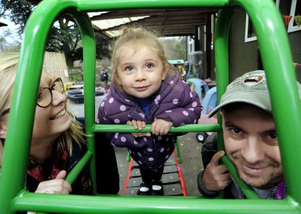 Aspley Guise Pre School pupil 

Lacy Chamberlain, 2, tries out the new climbing frame, with Hannah Buckingham, Early Years Practitioner and Mikel Toci, from Amazon who donated the equipment.