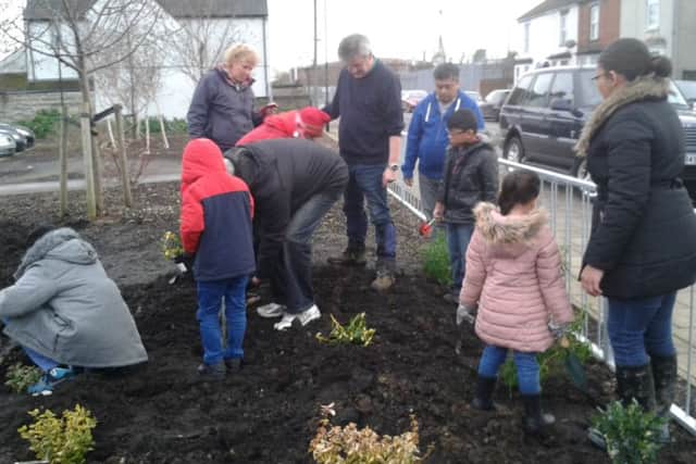 Pupils from St Joseph's Catholic School join the Queen's Park Community Orchard to plant shrubs