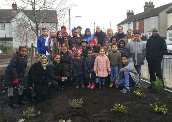 Pupils from St Joseph's Catholic School join the Queen's Park Community Orchard to plant shrubs
