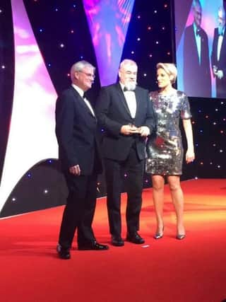 Steve Green (centre) receiving his award for technician of the year from BBC presenter Steph McGovern.