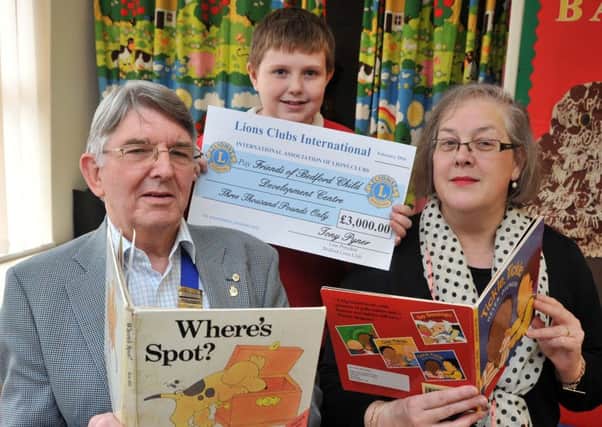 President of Bedford Lions Club Tony Pyner presents a cheque  for Â£3,000 to Secretary of the Friend of the Child Deveopment Centre Amanda Young, with Cody Marsh, 11 PNL-160222-125056001