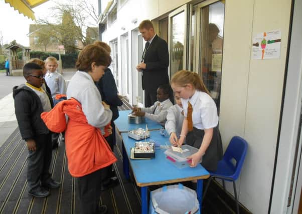 Young bakers at St John Rigby Primary School sell cakes for charity