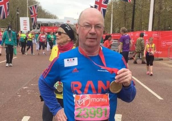 Alistair Burt MP crossing the London Marathon finish line PNL-160405-113928001
