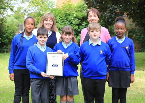 Castle Newnham Quality Mark Award - head teacher Ruth Wilkes, left, and achievement leader for closing gaps Ali Boston with pupils. Picture: Alexander J. Westley