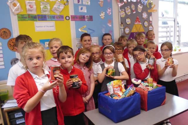 Year 3 at Robert Peel collect tins during MADD day.