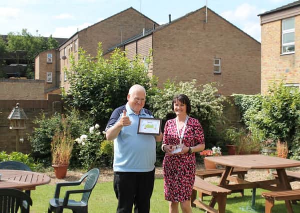 Terry Stephens receives his award from Marie Taylor, Head of Supported and Retirement Housing at bpha.