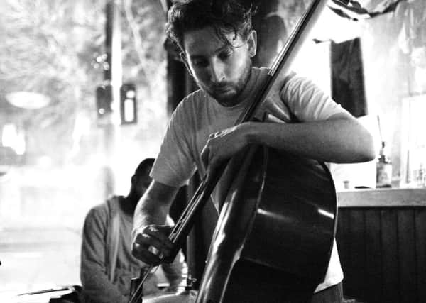 Ferg Ireland plays double bass for the trio