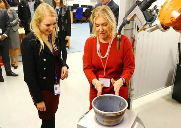 Graduate engineer Katharine Allison shows Nadine Dorries MP the 3-D cutting edge technology Wire Arc Additive Manufacturing (WAAM) capability during her visit to Lockheed Martin UK Ampthill.