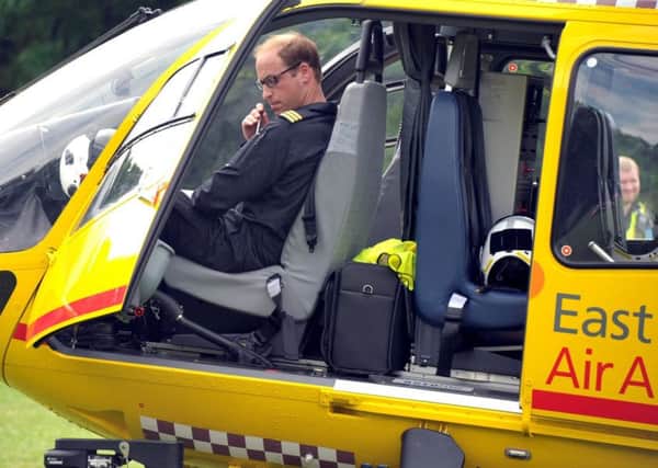 FILE PICTURE - Prince William in his East Anglian Air Ambulance in Wisbech Park, Cambs.  July 16, 2015. See MASONS story MNLETTER: Prince William has penned a heartwarming letter thanking his colleagues at the East Anglian Air Ambulance as he clocks off on his final shift. The Duke of Cambridge leaves his role as a pilot for the East Anglian Air Ambulance today (thu) after two years of service. As he departs to begin full time Royal duties, he sent a letter to a local newspaper telling of his pride at doing the job with the charity. In the letter, Prince William said his two years in the role had exposed him to 'moments of extreme emotion' and he promised to continue to support emergency services staff after his time with the charity is up.