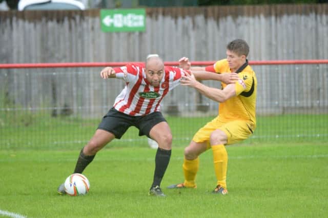 Callum Lewis holds off his Hereford opponent